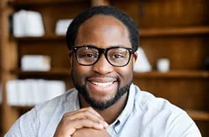 Career Marketing Techniques - Young black male with glasses and a blue shirt