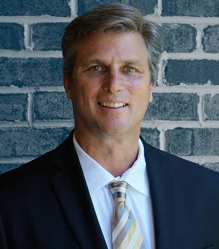 Career Marketing Techniques - Professional man in a dark suit with a yellow tie
