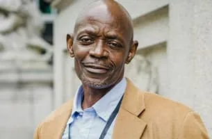 Career Marketing Techniques - Senior black man with blue shirt and tan blazer